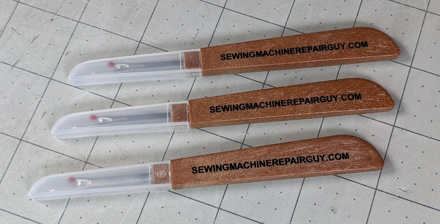 Three seam rippers and one logo sticker for Sewing Machine Repair Guy